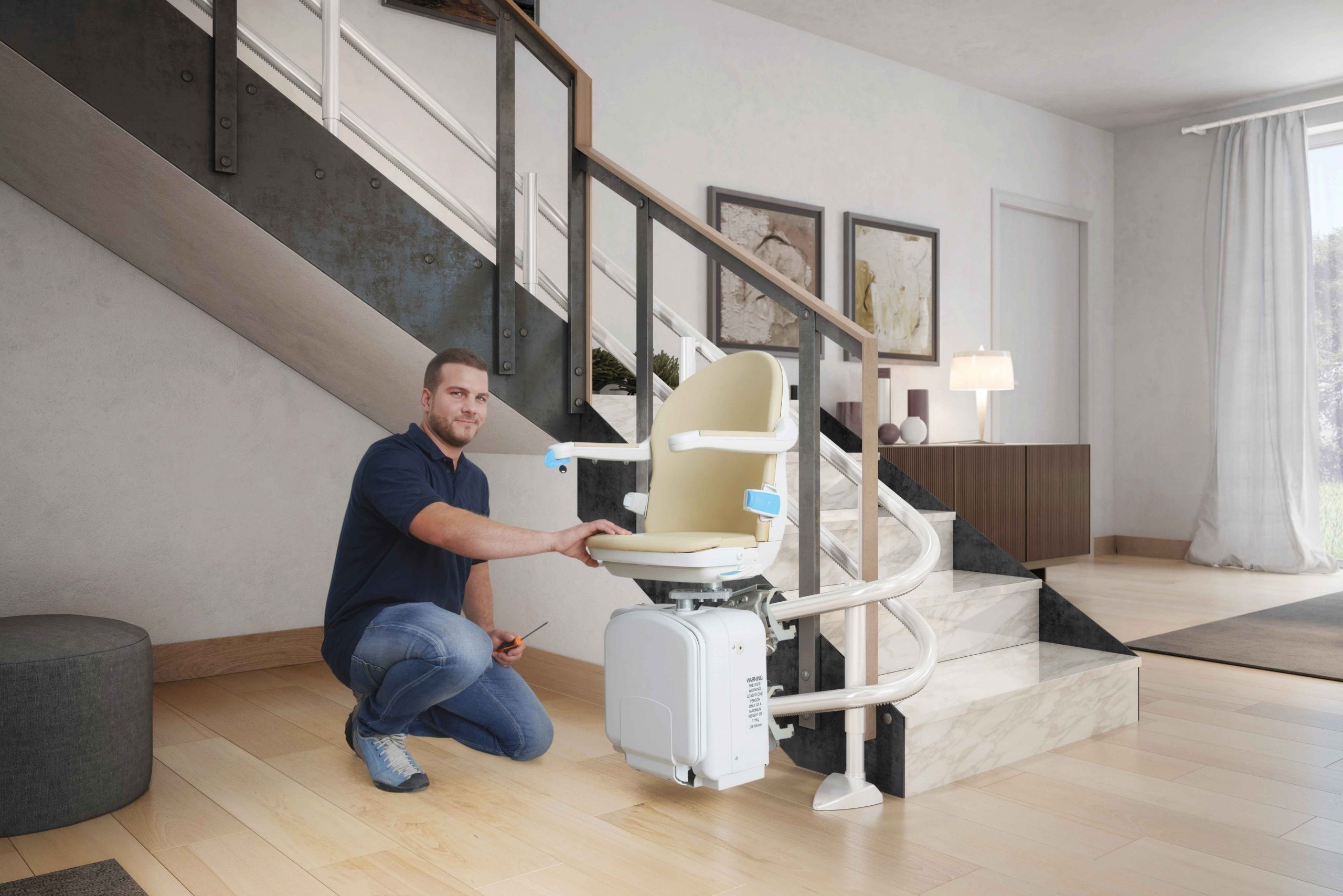 Modern Mobility Stairlift engineer installing a curved stairlift