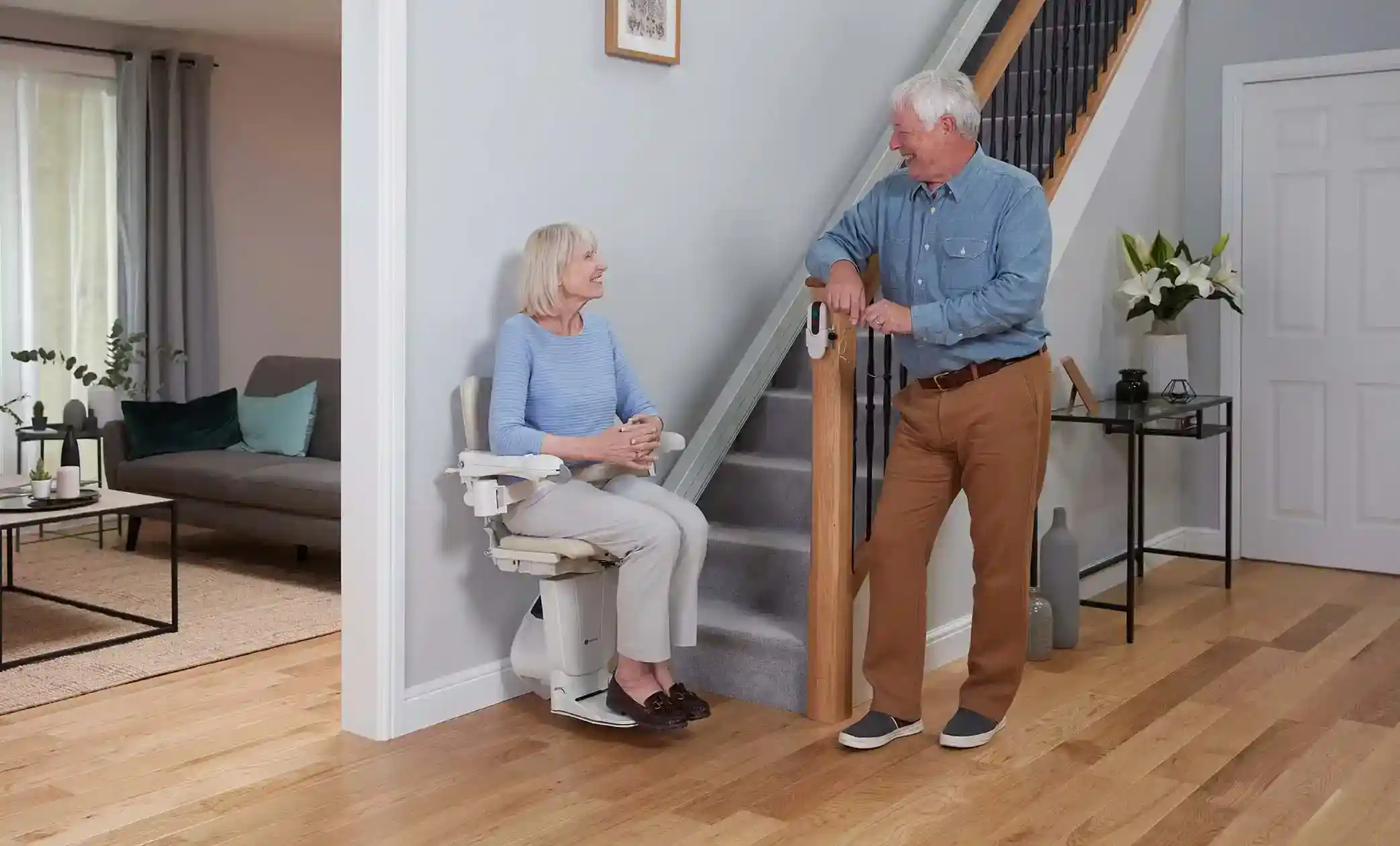 couple smiling using their handicare stairlift